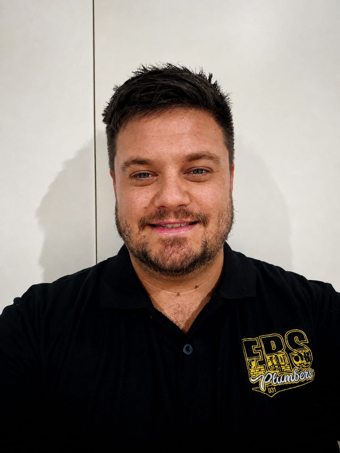 Brendan from ERS Plumbers in a branded work shirt