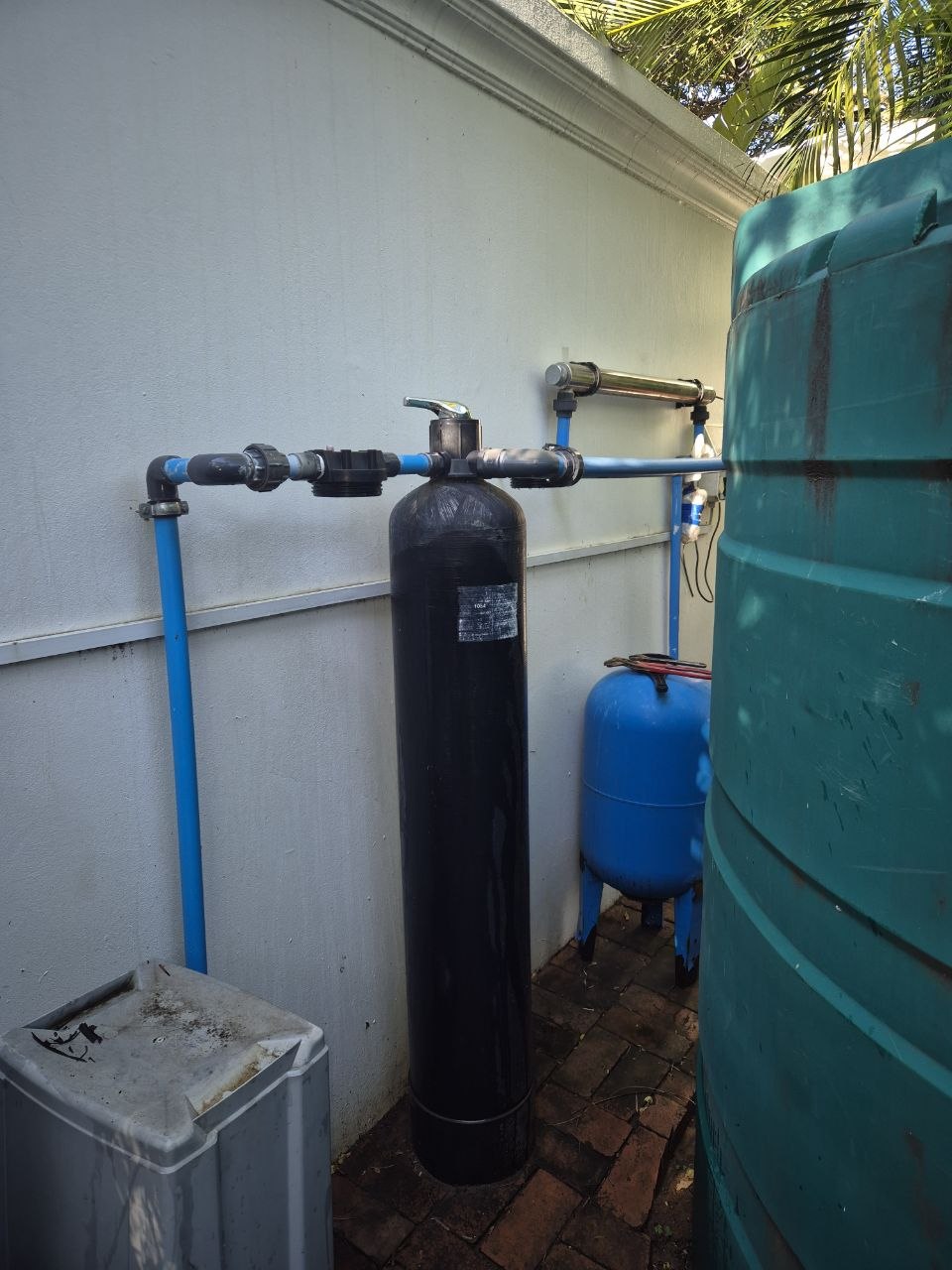 Water filtration system reassembled beside a JoJo tank by ERS Plumbers